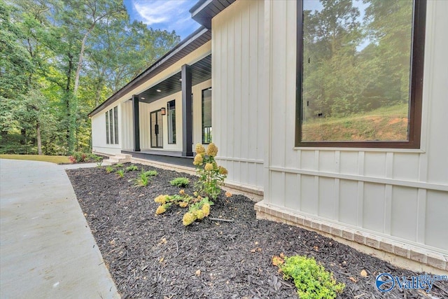 view of property exterior with board and batten siding and a porch