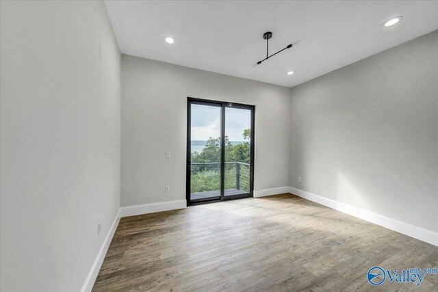 unfurnished room featuring hardwood / wood-style flooring