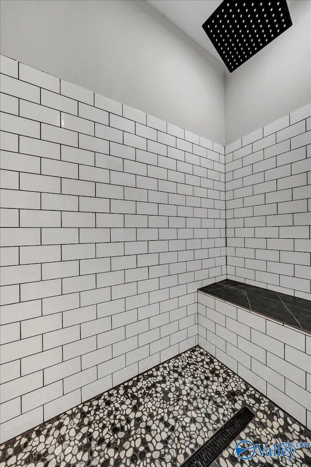 full bath featuring a tile shower