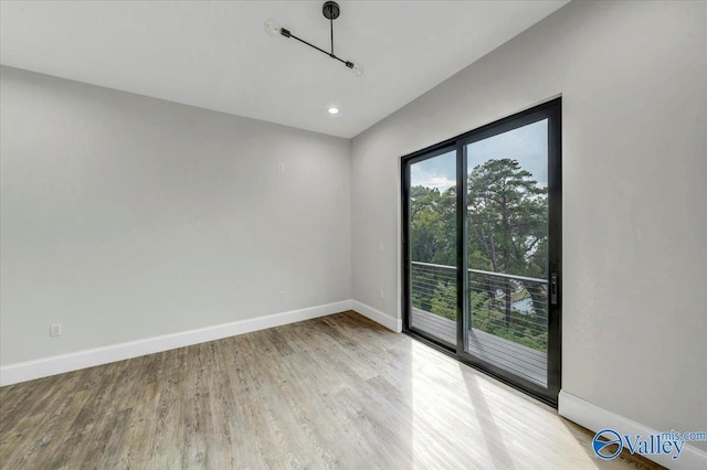 unfurnished room with light wood-type flooring, baseboards, and recessed lighting