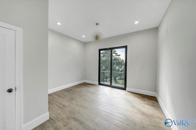 unfurnished room with light wood-type flooring, baseboards, and recessed lighting