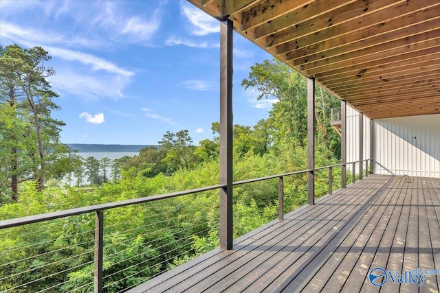 wooden terrace featuring a water view