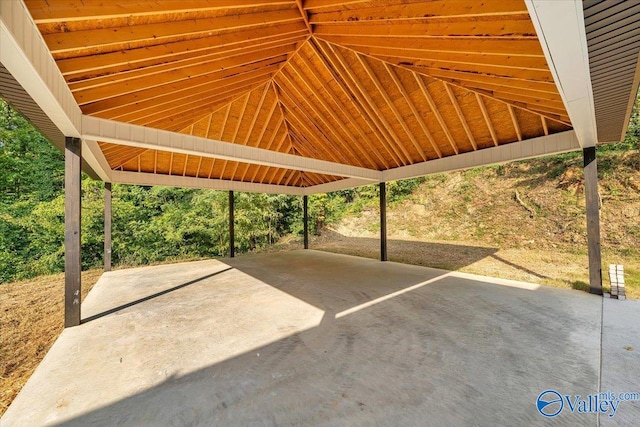 view of parking / parking lot featuring a carport and concrete driveway