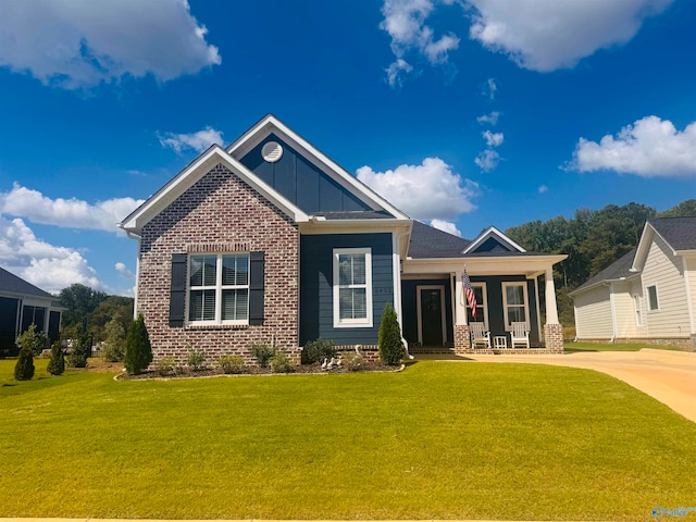 craftsman house with covered porch and a front yard