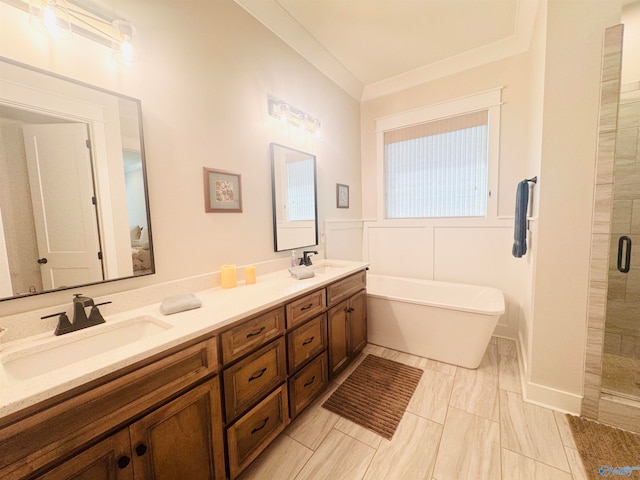 bathroom featuring crown molding, vanity, and separate shower and tub