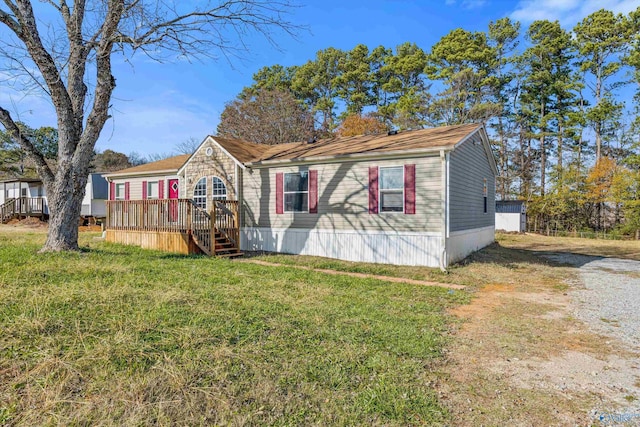 view of front facade featuring a deck and a front yard