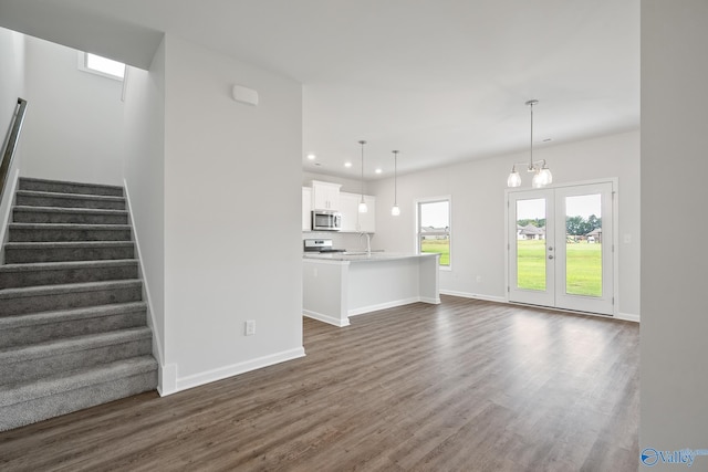 REVERE2 Saddle St, New Market, AL 35761 - unfurnished living room featuring stairs, dark wood-style floors, baseboards, recessed lighting, and an inviting chandelier