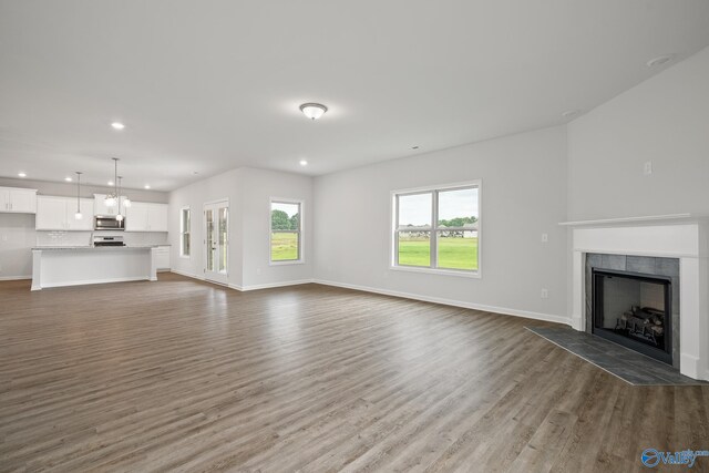 REVERE2 Saddle St, New Market, AL 35761 - unfurnished living room with baseboards, a tile fireplace, recessed lighting, and dark wood finished floors