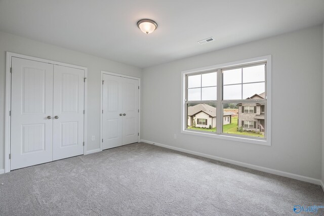 REVERE2 Saddle St, New Market, AL 35761 - unfurnished bedroom featuring baseboards, multiple closets, visible vents, and carpet