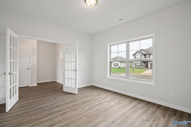 REVERE2 Saddle St, New Market, AL 35761 - empty room featuring baseboards, visible vents, wood finished floors, and french doors