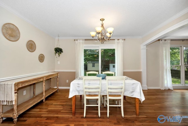 1867 Shellbrook Dr, Huntsville, AL 35806 - dining area with a chandelier, wood finished floors, crown molding, a textured ceiling, and baseboards