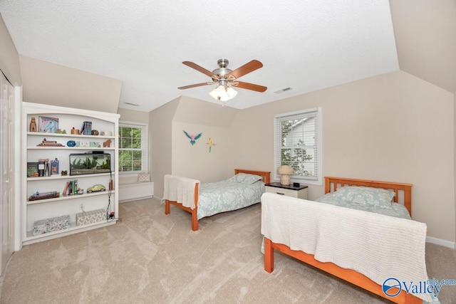 1867 Shellbrook Dr, Huntsville, AL 35806 - bedroom with light carpet, multiple windows, lofted ceiling, ceiling fan, and baseboards