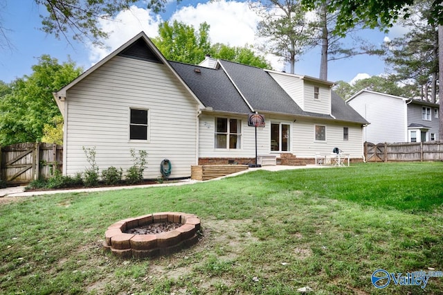1867 Shellbrook Dr, Huntsville, AL 35806 - back of property with an outdoor fire pit, a gate, a shingled roof, and entry steps