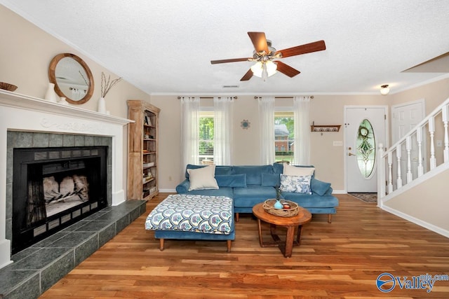 1867 Shellbrook Dr, Huntsville, AL 35806 - living room featuring ceiling fan, wood finished floors, stairway, a textured ceiling, and ornamental molding