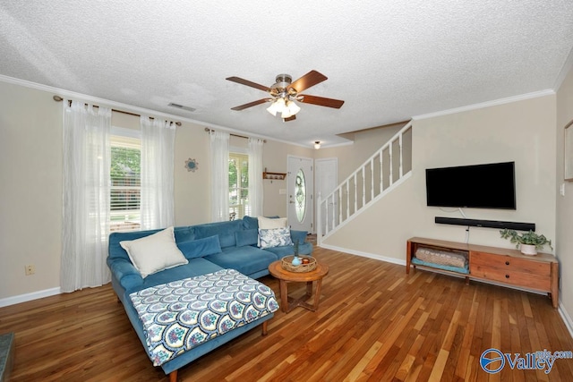 1867 Shellbrook Dr, Huntsville, AL 35806 - living area with stairway, wood finished floors, a ceiling fan, a textured ceiling, and ornamental molding