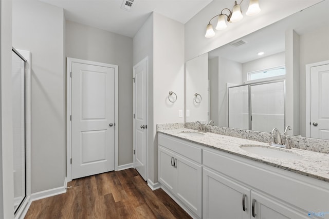 208 Hibiscus Dr, Hazel Green, AL 35750 - full bathroom with a sink, a shower stall, wood finished floors, and visible vents