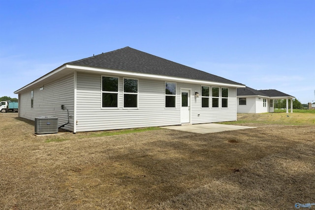 208 Hibiscus Dr, Hazel Green, AL 35750 - back of house featuring a patio, central air condition unit, a yard, and a shingled roof