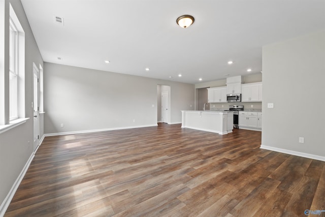 208 Hibiscus Dr, Hazel Green, AL 35750 - unfurnished living room with recessed lighting, a sink, visible vents, baseboards, and dark wood finished floors