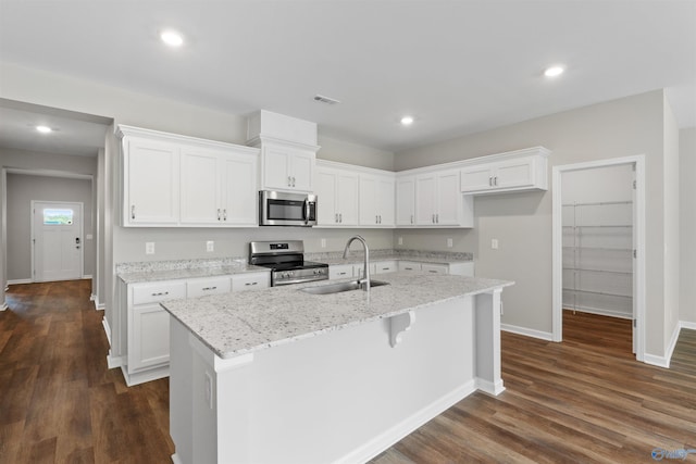 208 Hibiscus Dr, Hazel Green, AL 35750 - kitchen featuring baseboards, a kitchen island with sink, stainless steel appliances, a sink, and white cabinetry