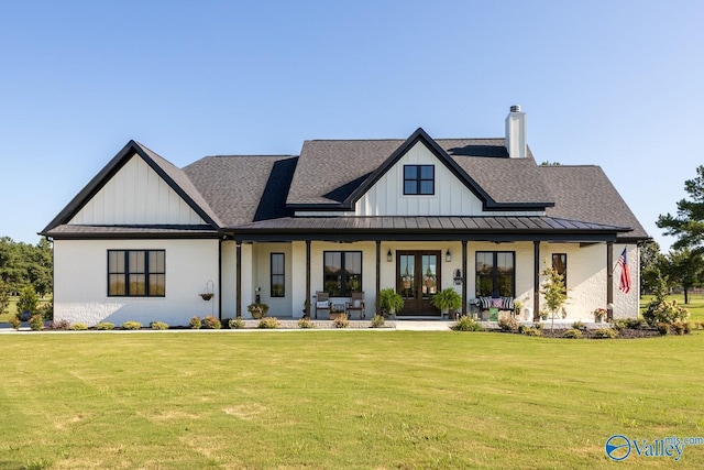 modern farmhouse style home featuring a porch and a front lawn