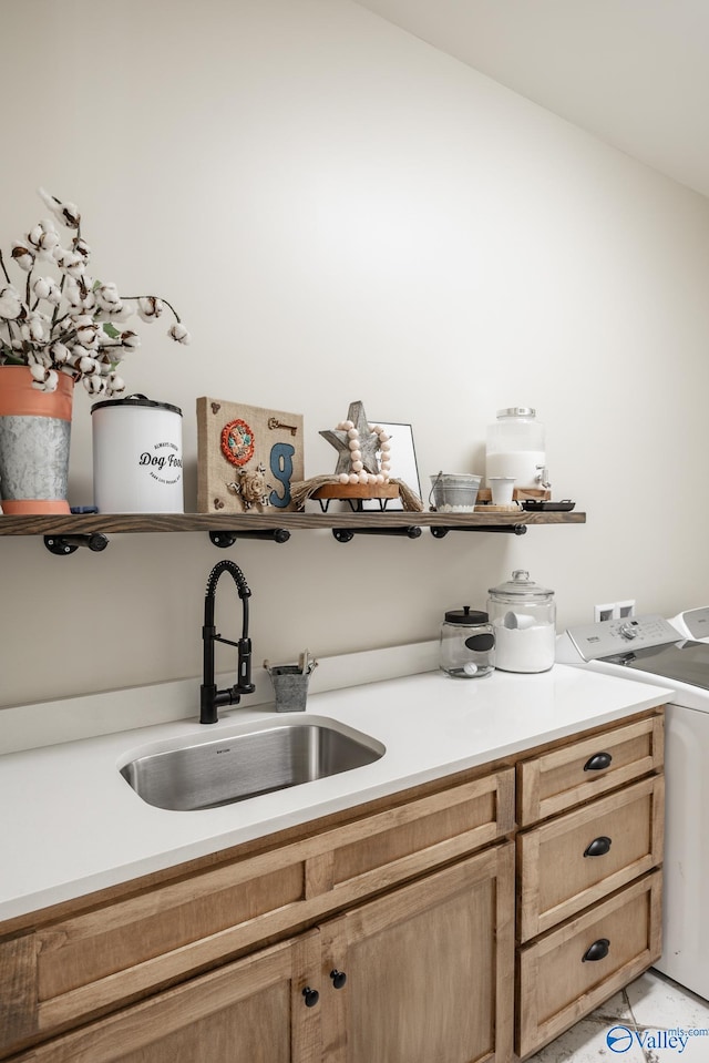 bathroom featuring sink, separate washer and dryer, and tile patterned flooring