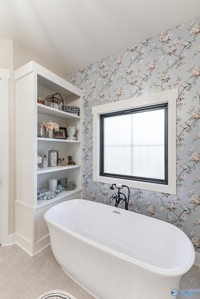 bathroom with tile patterned floors and a tub