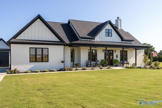 view of front of house with a front yard and covered porch