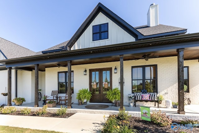 rear view of property with covered porch, ceiling fan, and french doors