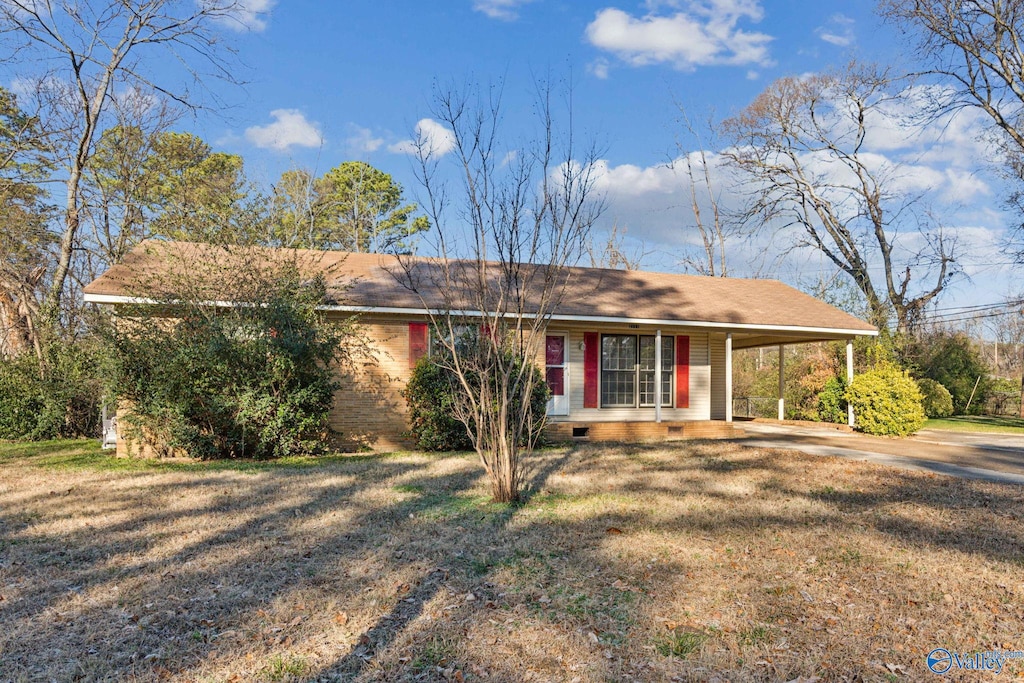 single story home with a carport, covered porch, and a front yard