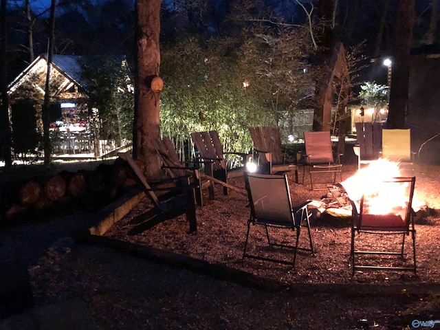 yard at night with an outdoor fire pit