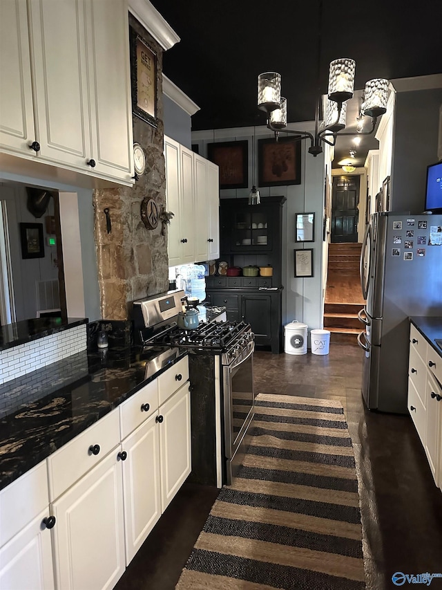 kitchen with stainless steel appliances, backsplash, dark hardwood / wood-style floors, dark stone countertops, and white cabinetry