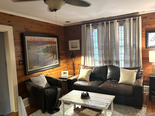 living room featuring wood walls, ceiling fan, and crown molding