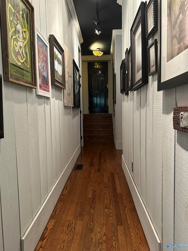 hall with dark hardwood / wood-style floors and crown molding