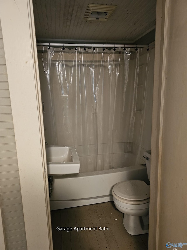 bathroom with hardwood / wood-style floors, shower / bath combo, toilet, and wooden ceiling