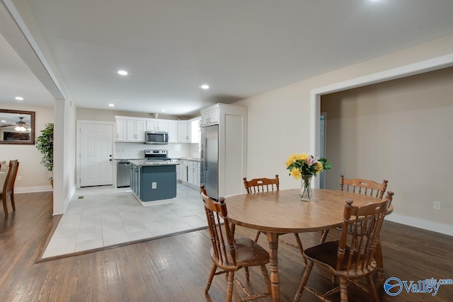 dining room featuring light hardwood / wood-style flooring and ceiling fan