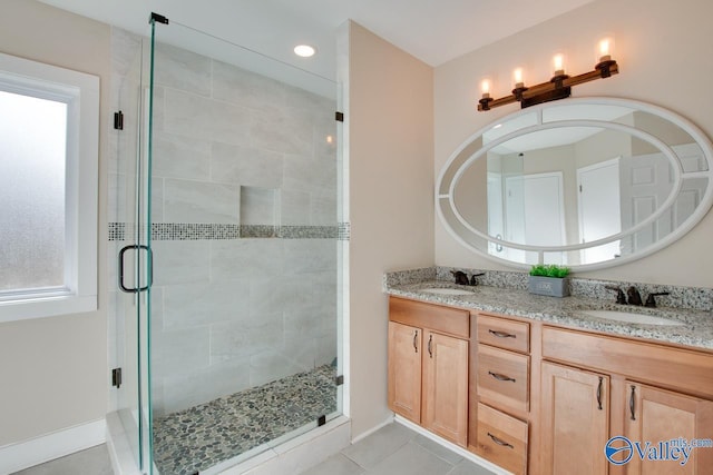 bathroom with vanity, tile patterned floors, and a shower with door