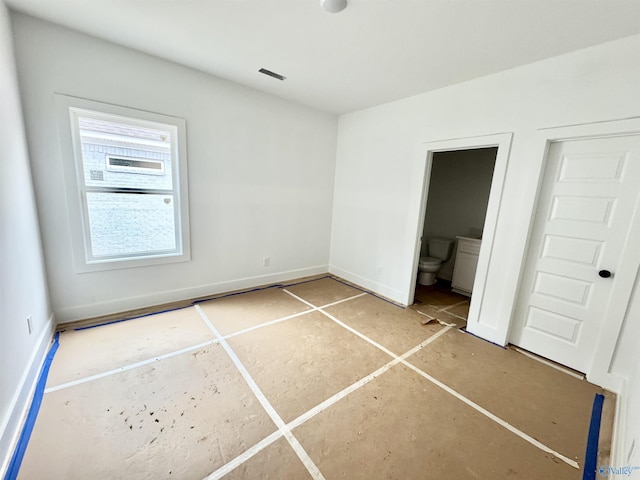 unfurnished bedroom featuring connected bathroom