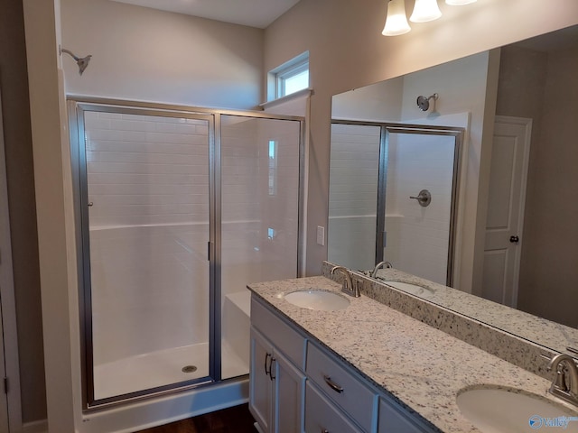 bathroom featuring an enclosed shower and vanity