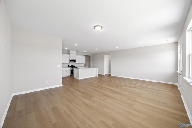 unfurnished living room featuring light wood-type flooring