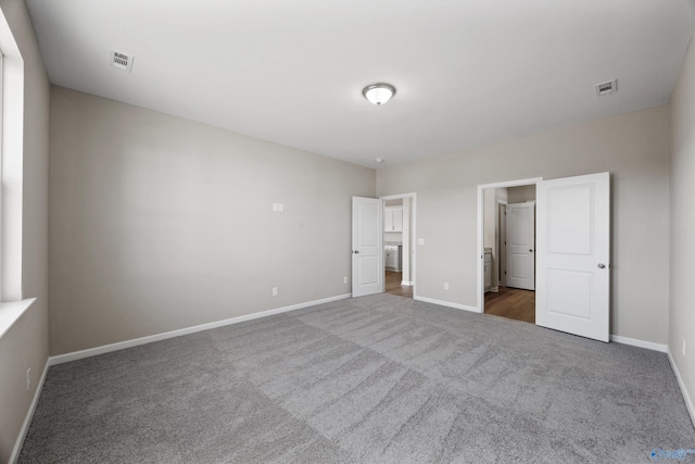 unfurnished bedroom featuring dark colored carpet