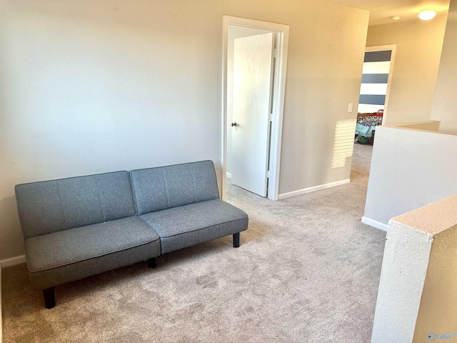 sitting room featuring carpet floors and baseboards