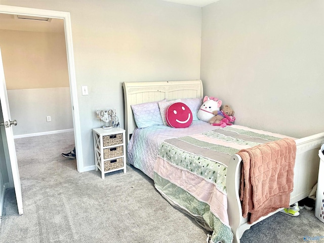 bedroom featuring baseboards, visible vents, and light colored carpet