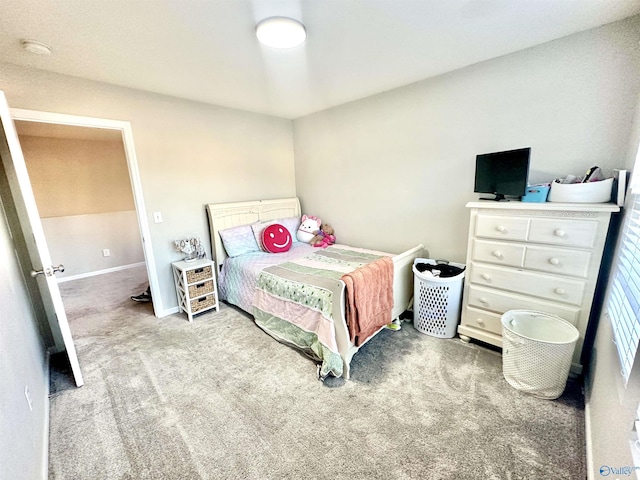 bedroom with light carpet and baseboards