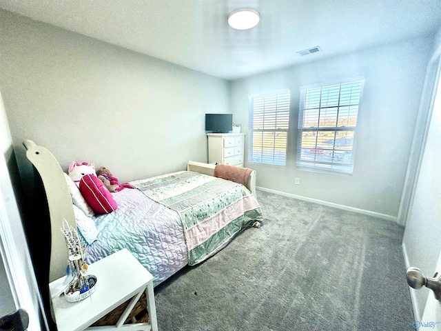 carpeted bedroom with visible vents and baseboards