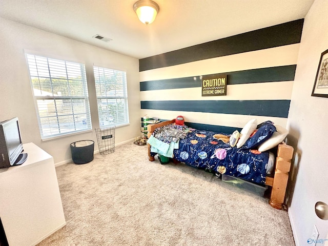 carpeted bedroom with visible vents and baseboards