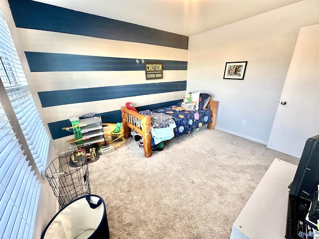 bedroom with carpet floors and baseboards