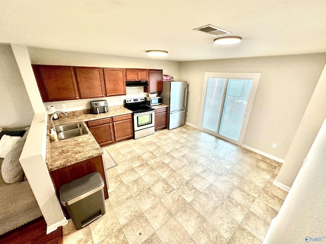 kitchen with baseboards, visible vents, appliances with stainless steel finishes, and a sink