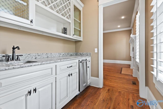 bar featuring sink, crown molding, dark hardwood / wood-style floors, light stone countertops, and white cabinets