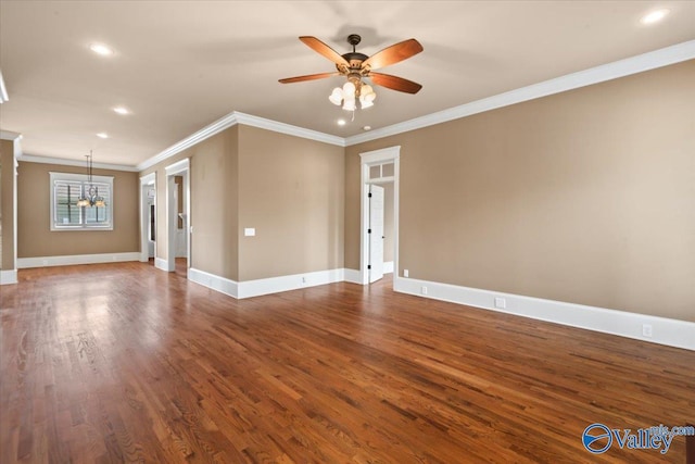 unfurnished room featuring crown molding, ceiling fan with notable chandelier, and dark hardwood / wood-style floors