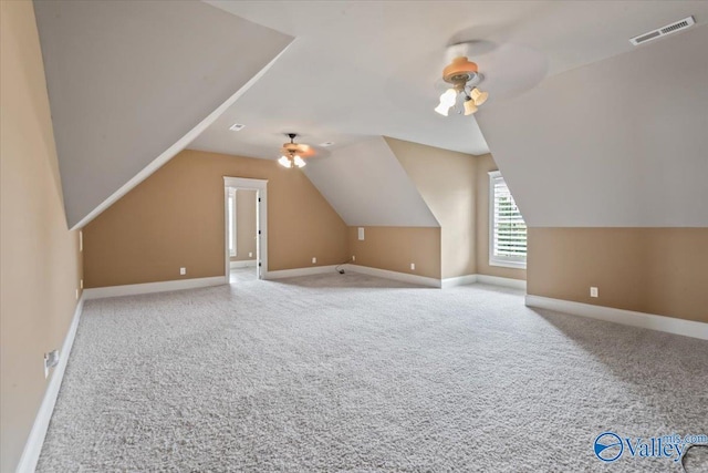 bonus room with light carpet, vaulted ceiling, and ceiling fan